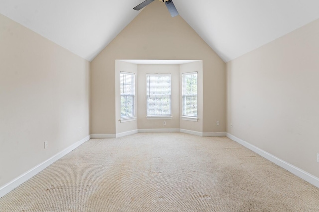 empty room featuring light carpet, ceiling fan, and baseboards