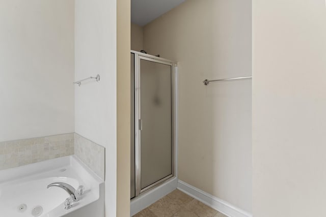 full bathroom with baseboards, a stall shower, tile patterned flooring, and a bath