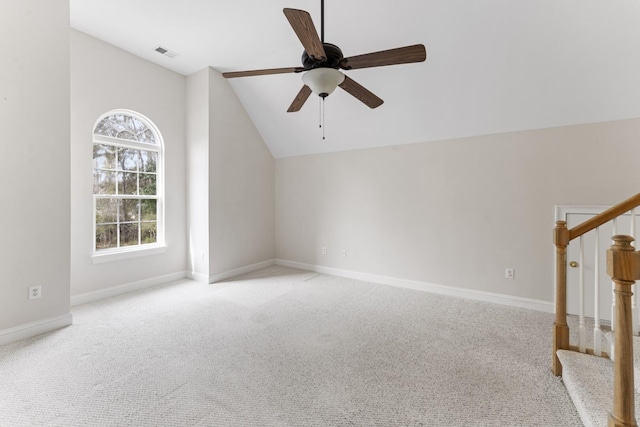 additional living space featuring visible vents, baseboards, stairs, vaulted ceiling, and light colored carpet