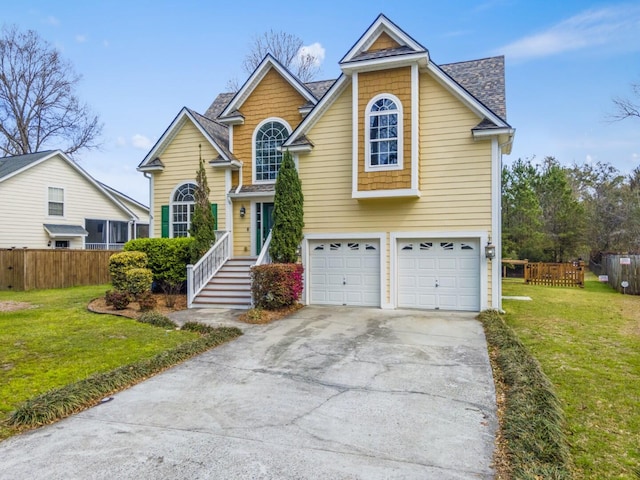 view of front facade featuring a front lawn, concrete driveway, fence, and a garage