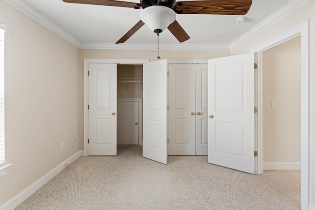 unfurnished bedroom with light carpet, baseboards, crown molding, and multiple closets