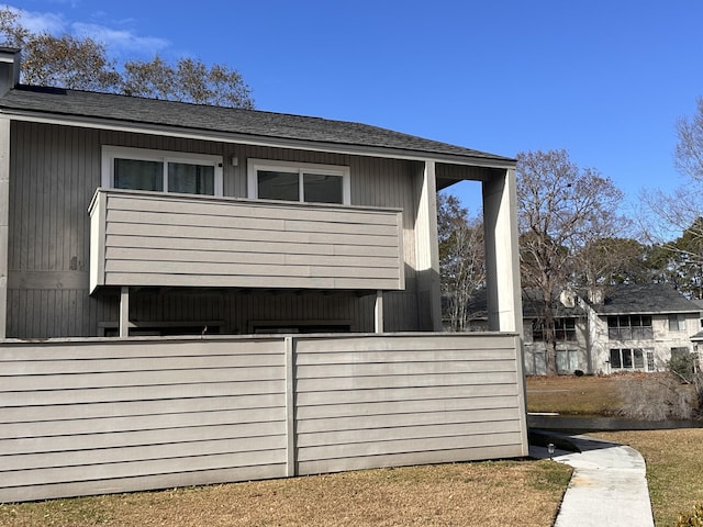 view of side of property featuring a balcony