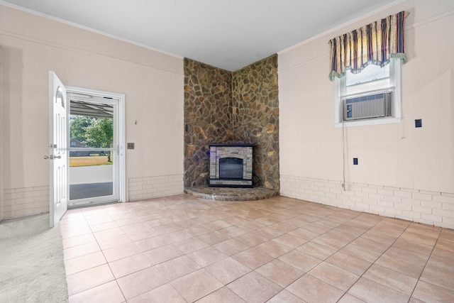 101 Parkside Dr, Goose Creek, SC 29445 - unfurnished living room featuring crown molding, cooling unit, a stone fireplace, and tile patterned flooring