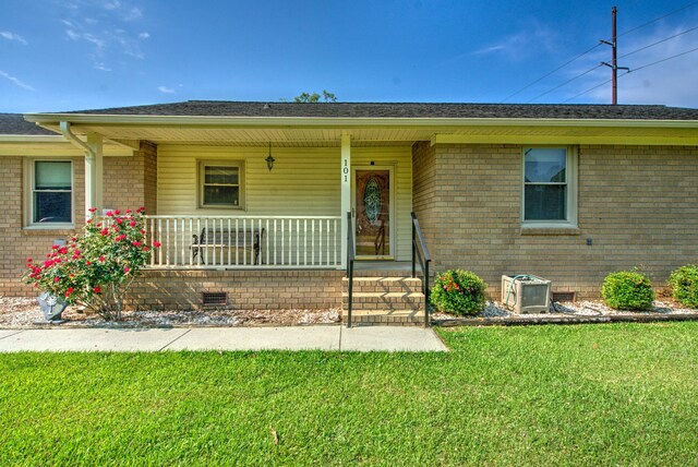 101 Parkside Dr, Goose Creek, SC 29445 - view of front facade featuring covered porch, brick siding, a front lawn, crawl space, and a shingled roof