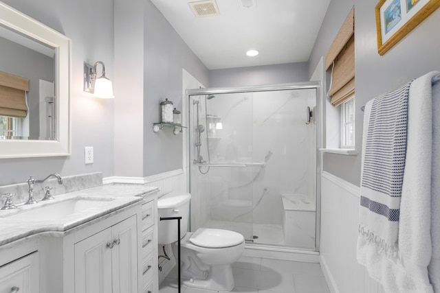1604 Macoma Dr, Mount Pleasant, SC 29466 - bathroom with toilet, vanity, a marble finish shower, a wainscoted wall, and tile patterned floors