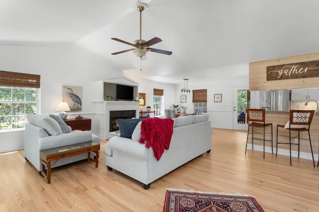 1604 Macoma Dr, Mount Pleasant, SC 29466 - living room with ceiling fan, light wood-type flooring, healthy amount of natural light, lofted ceiling, and a warm lit fireplace