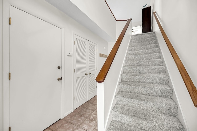 stairway featuring tile patterned floors