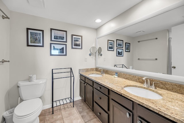 bathroom featuring toilet, vanity, and tile patterned flooring