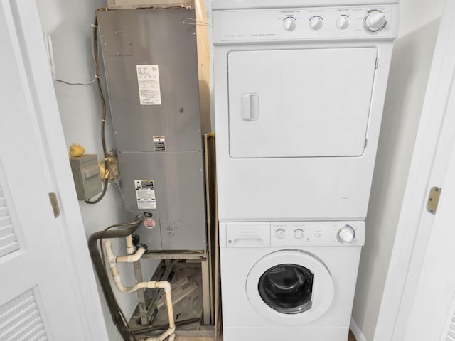 clothes washing area with stacked washer and dryer