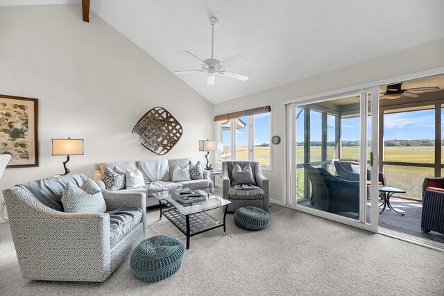 carpeted living room with a healthy amount of sunlight, beam ceiling, high vaulted ceiling, and ceiling fan