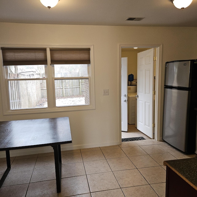 unfurnished dining area with light tile patterned floors