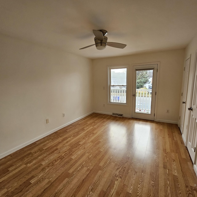 empty room with ceiling fan and light wood-type flooring