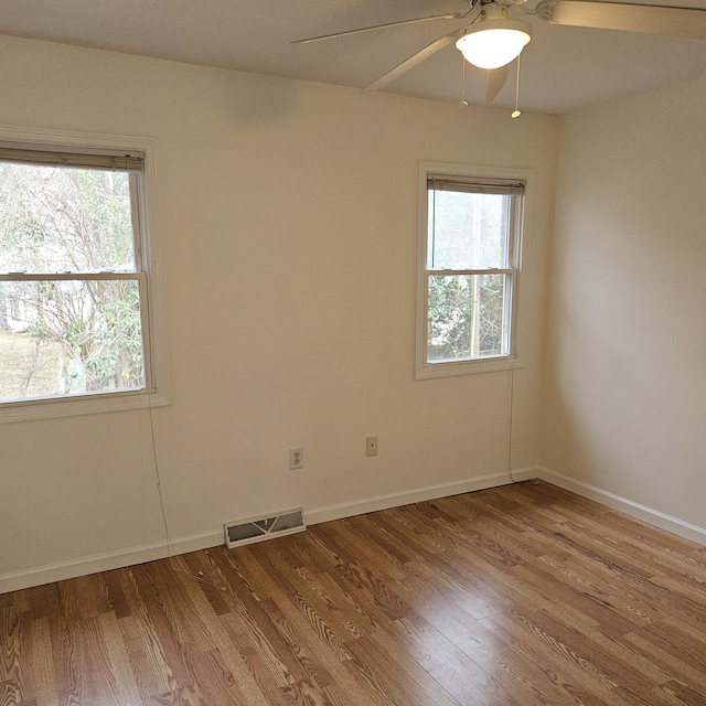 spare room with hardwood / wood-style flooring and ceiling fan