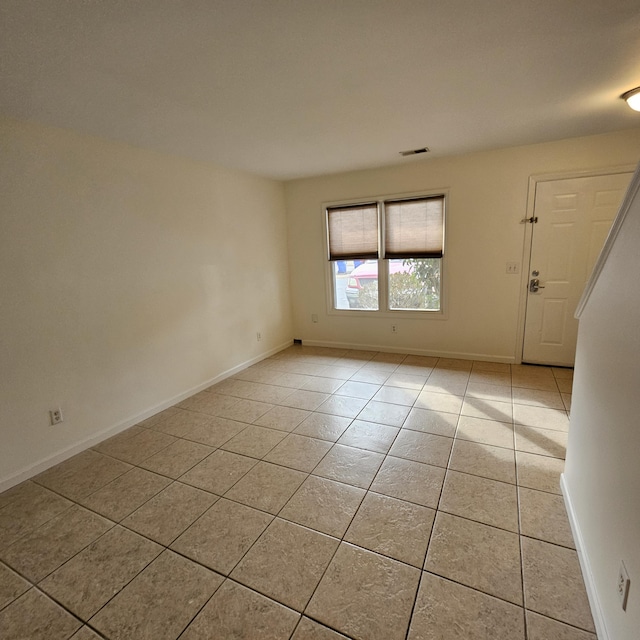 unfurnished room featuring light tile patterned floors