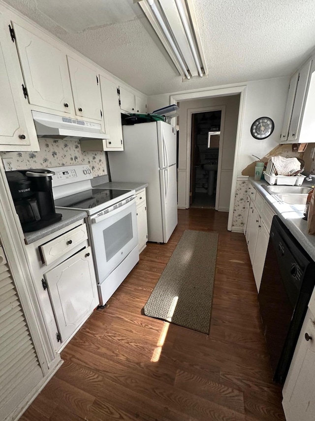 kitchen with under cabinet range hood, white cabinets, white appliances, and a sink