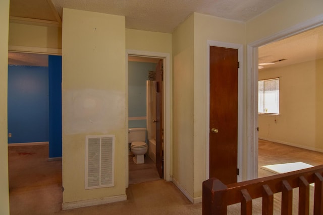 hallway featuring a textured ceiling