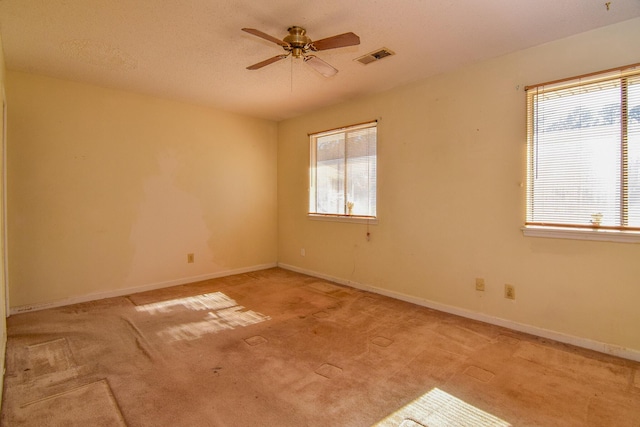 carpeted spare room featuring ceiling fan