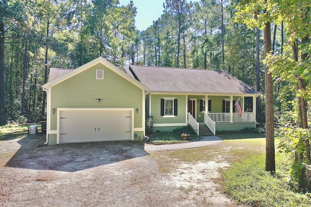 single story home featuring a porch and a garage