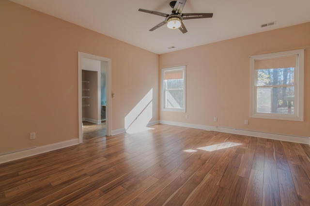 spare room featuring ceiling fan and dark hardwood / wood-style flooring