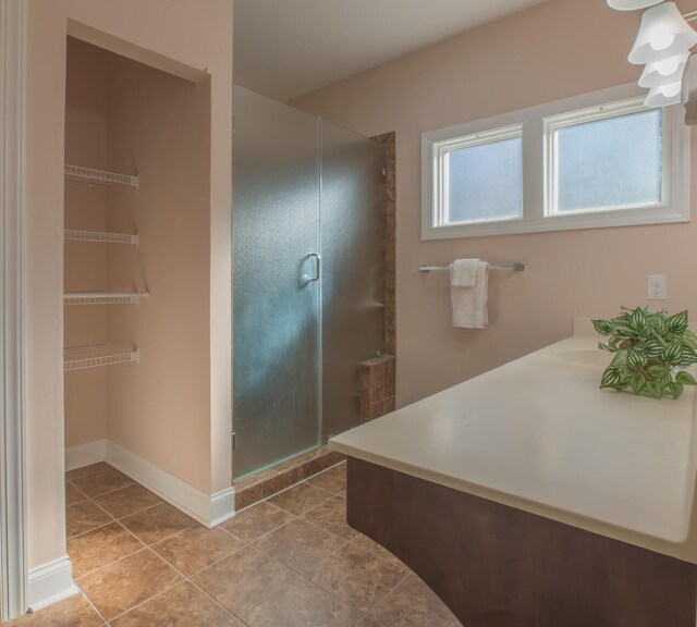 bathroom featuring tile patterned floors, vanity, and an enclosed shower