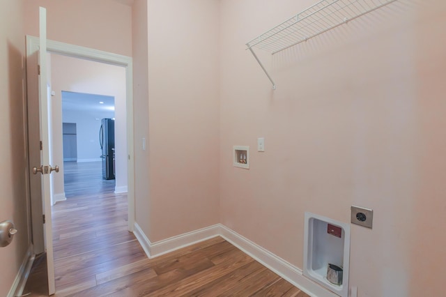 washroom featuring washer hookup, electric dryer hookup, and hardwood / wood-style floors