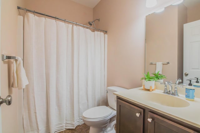 bathroom featuring tile patterned flooring, a shower with curtain, vanity, and toilet