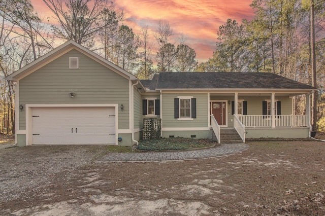 single story home featuring covered porch and a garage