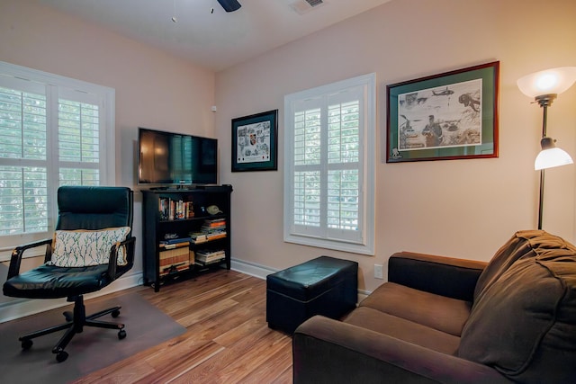 office with ceiling fan and light hardwood / wood-style floors