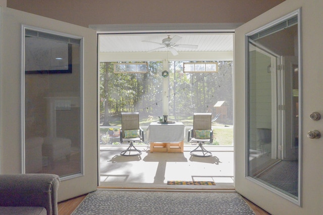 doorway featuring ceiling fan and hardwood / wood-style flooring