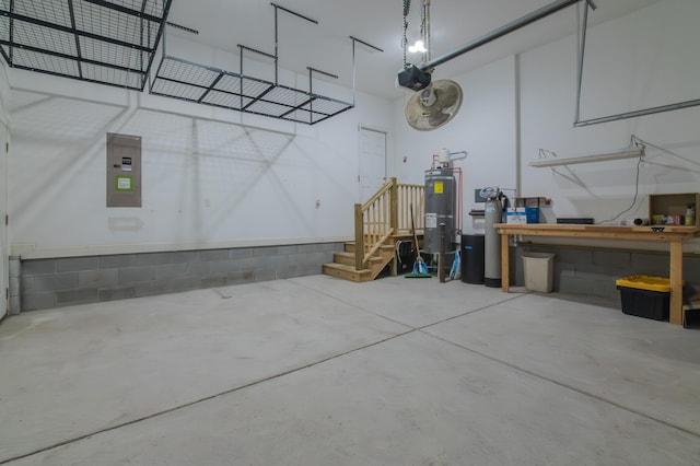 garage featuring a workshop area, a garage door opener, and water heater