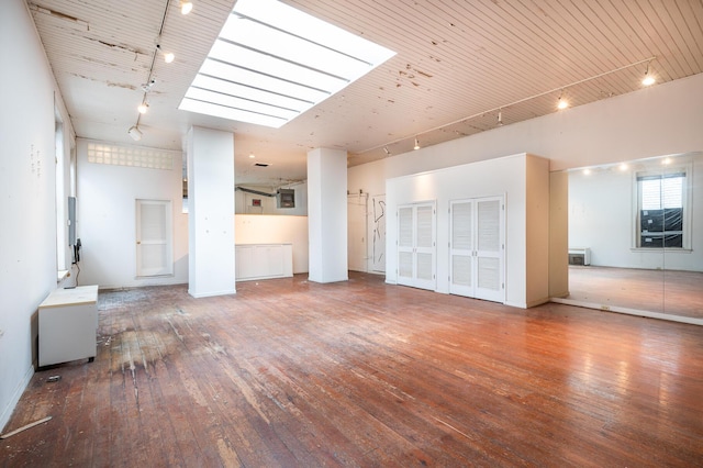354 King St Unit B, Charleston, SC 29401 - unfurnished living room featuring rail lighting, hardwood / wood-style floors, a skylight, and wood ceiling