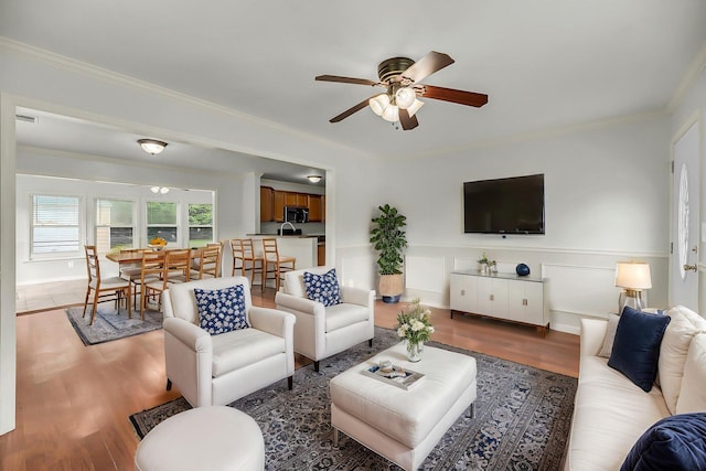 1239 Old Orchard Rd, Charleston, SC 29412 - living room with wainscoting, wood finished floors, ornamental molding, and ceiling fan