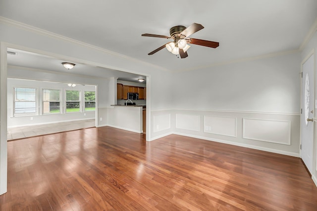 1239 Old Orchard Rd, Charleston, SC 29412 - unfurnished living room with a decorative wall, ornamental molding, a ceiling fan, a wainscoted wall, and wood finished floors