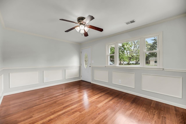 1239 Old Orchard Rd, Charleston, SC 29412 - unfurnished room with ornamental molding, a ceiling fan, a wainscoted wall, visible vents, and wood finished floors