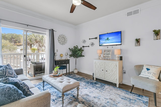 living room with ceiling fan, hardwood / wood-style floors, and crown molding