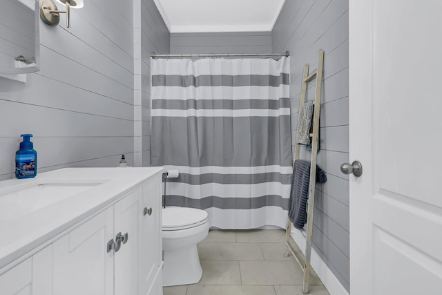 bathroom with curtained shower, tile patterned flooring, vanity, toilet, and wood walls