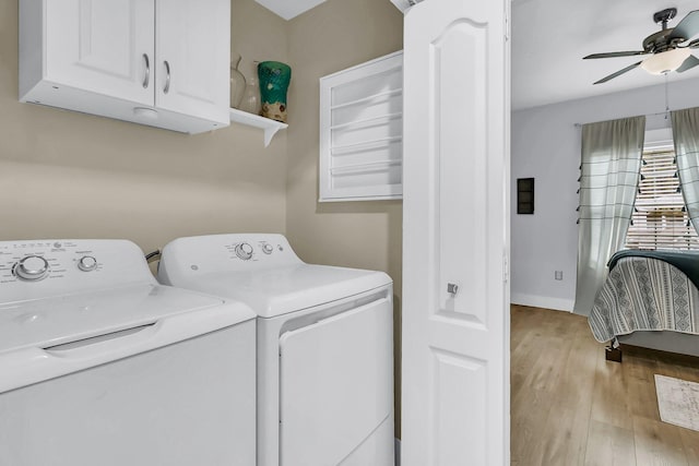 laundry room featuring ceiling fan, cabinets, light hardwood / wood-style flooring, and washing machine and clothes dryer