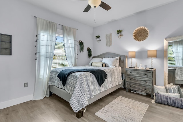 bedroom with ceiling fan and hardwood / wood-style floors