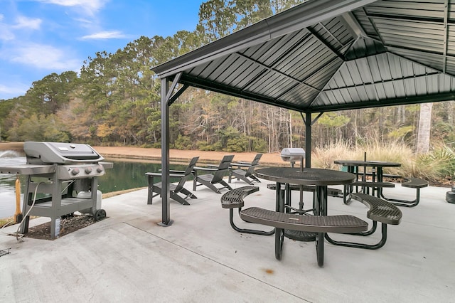 view of patio / terrace featuring a gazebo, a water view, and a grill