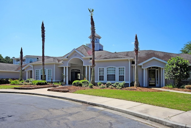 ranch-style home featuring a front yard