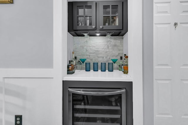 bar with beverage cooler and tasteful backsplash