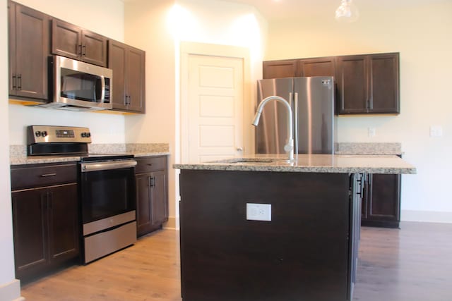 303 Citation Way, Moncks Corner, SC 29461 - kitchen with stainless steel appliances, light wood-style flooring, and dark brown cabinetry