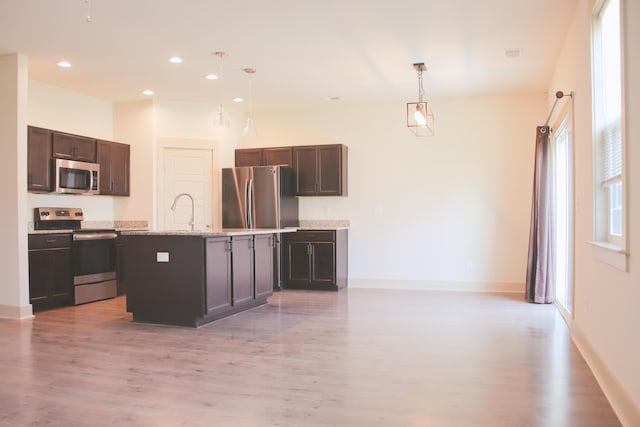 303 Citation Way, Moncks Corner, SC 29461 - kitchen with appliances with stainless steel finishes, light wood-type flooring, dark brown cabinets, decorative light fixtures, and recessed lighting