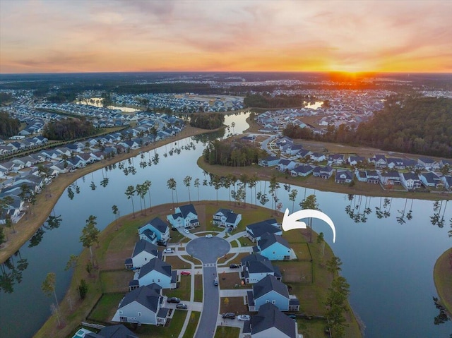 aerial view at dusk with a water view