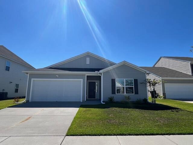 ranch-style home with a front lawn and a garage