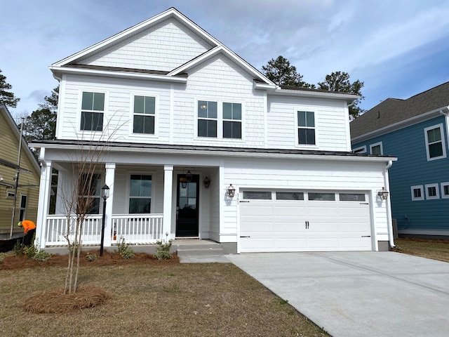 view of front of property featuring covered porch, driveway, a standing seam roof, and a garage