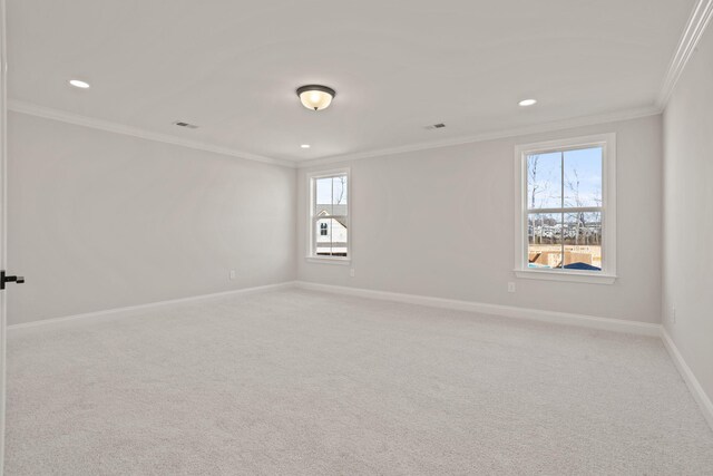 empty room with baseboards, recessed lighting, light carpet, and crown molding