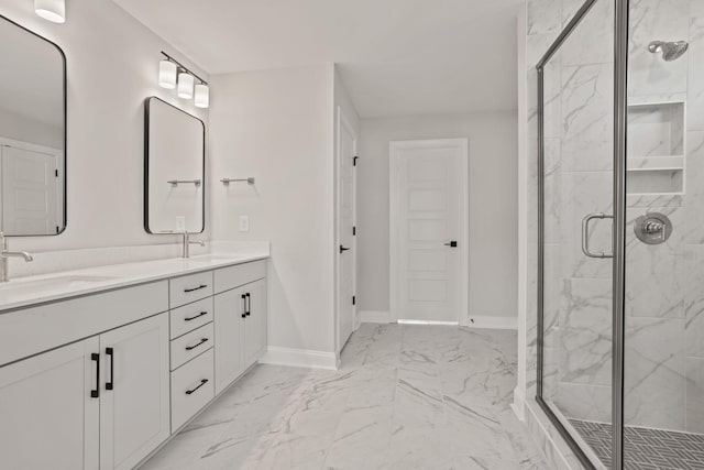 full bath with marble finish floor, a marble finish shower, baseboards, and a sink