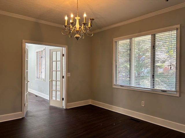 spare room featuring a chandelier, dark hardwood / wood-style flooring, and ornamental molding