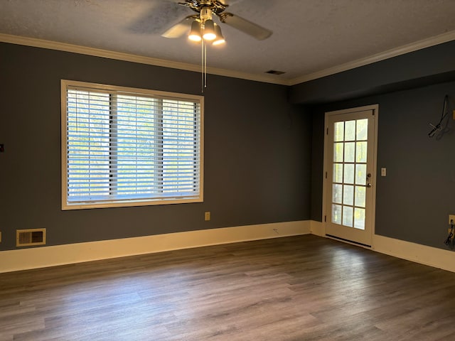 empty room with dark hardwood / wood-style floors, ceiling fan, and crown molding